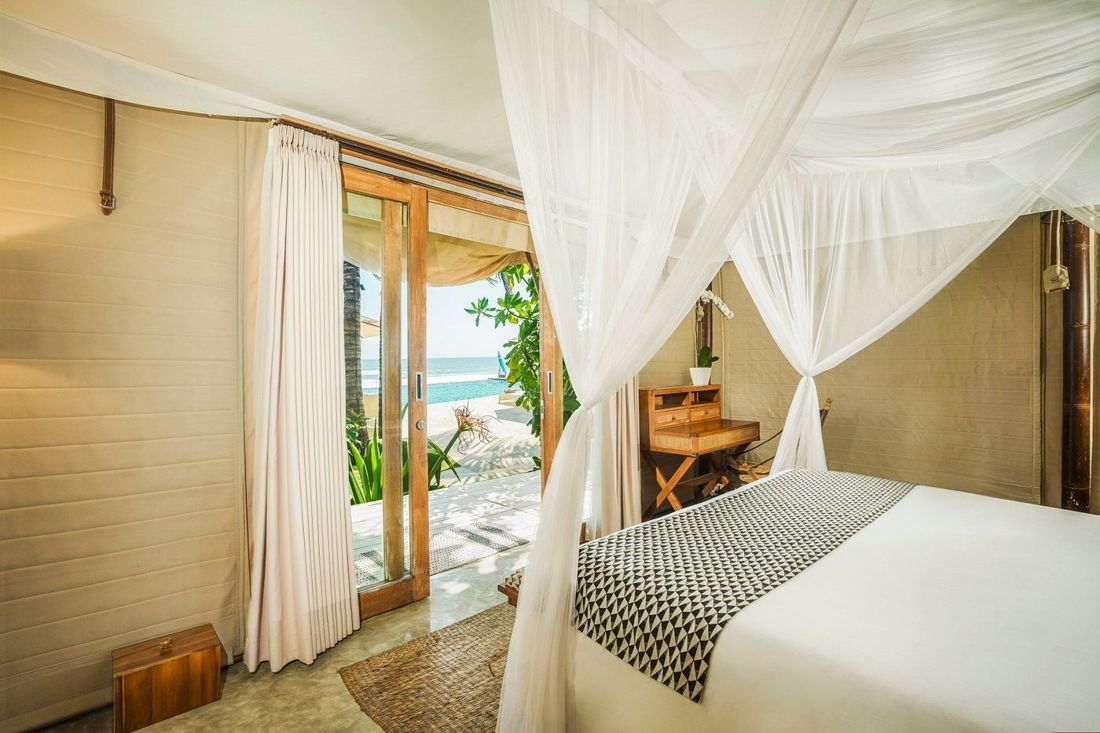 A tent bedroom opening onto the beach