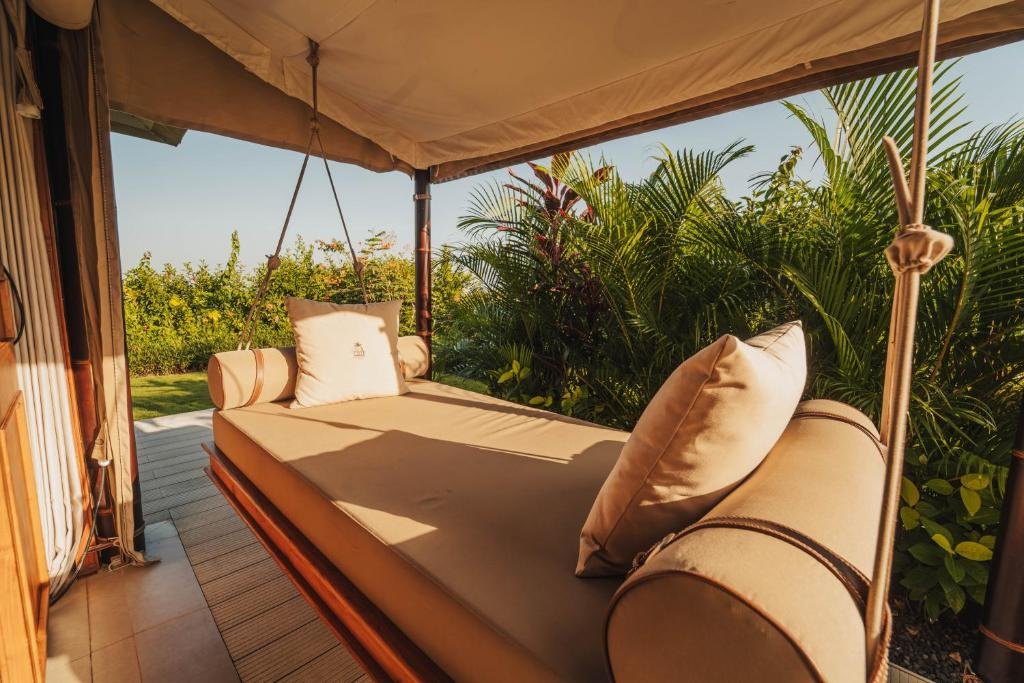 A hanging daybed on a tent terrace