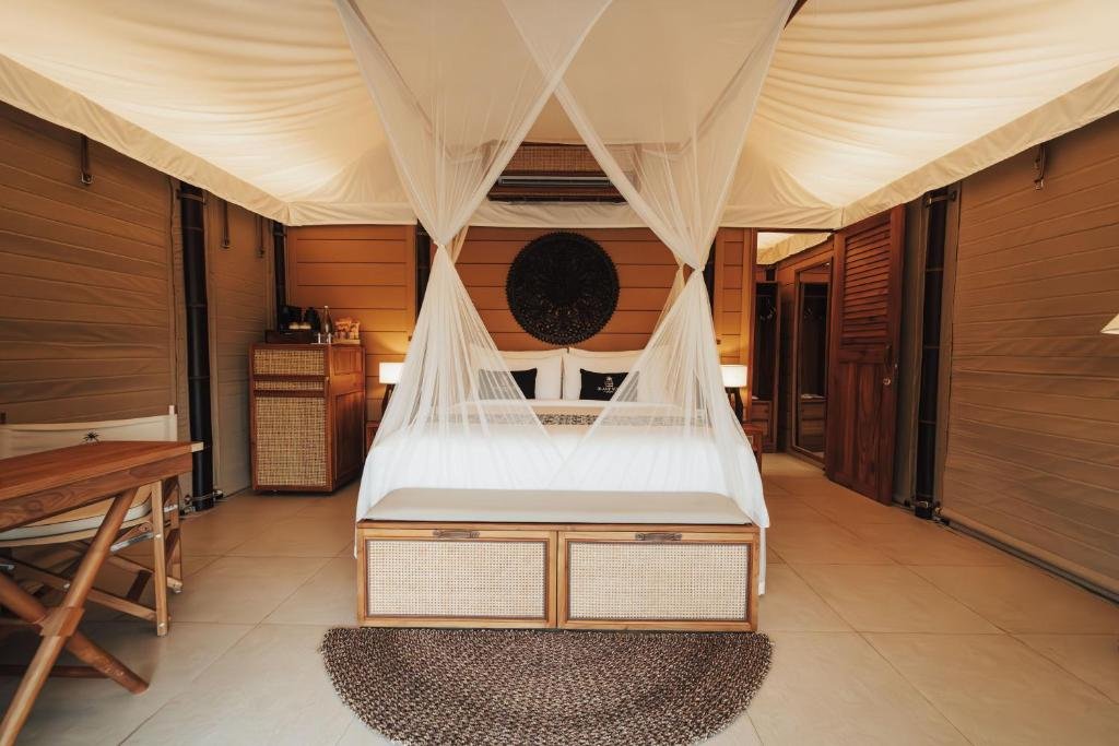A canopy bed inside a Glamp Nusa tent